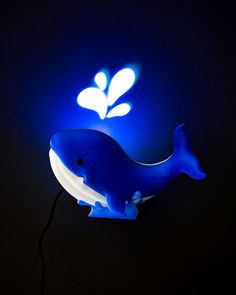 a blue whale lamp sitting on top of a table