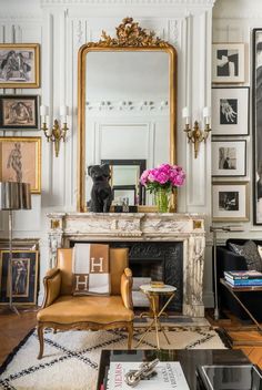 a living room filled with lots of furniture and pictures on the wall next to a fire place