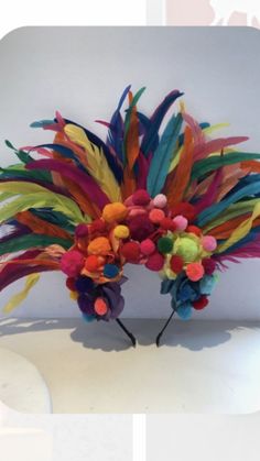 a colorful headpiece with feathers and flowers on it