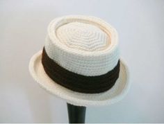 a crocheted hat on a black and white stand