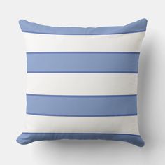 a blue and white striped pillow sitting on top of a wall