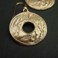 "Hand carved flying Japanese crane earrings. Throughout all of Asia, the crane has been a symbol of happiness and eternal youth. In Japanese, Chinese, and Korean tradition, cranes stand for good fortune and longevity because of its fabled life span of a thousand years. The Japanese refer to the crane as the \"bird of happiness\". The cranes' beauty and spectacular mating dances have made them highly symbolic birds in many cultures with records dating back to ancient times. Crane mythology is wid Traditional Gold Carved Earrings, Unique Engraved Earrings As A Gift, Unique Engraved Earrings For Gift, Engraved Earrings For Gifts, Formal Carved Gold Earrings, Formal Gold Carved Earrings, Symbolic Bronze Drop Earrings, Symbolic Engraved Gold Earrings, Symbolic Pierced Earrings For Anniversary