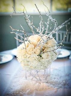 a vase filled with white flowers on top of a table