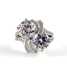 This is a vintage sterling silver ring with two large CZ's in the center approx 3.5 carats each. It is accented with cz diamonds on the outline of the setting as well as around the main stones. This is a used ring in very good condition. This ring is a size 7.75 and is marked SJ 925 on the inside of the band. It weighs approx 10.3 grams. Add this very flashy ring to your collection.  Visit our FAQ section: https://www.etsy.com/shop/KayZees?ref=hdr_shop_menu#more-section If you have any questions please don't hesitate to ask! Cubic Zirconia Cluster Ring For Anniversary, Luxury Silver Bypass Promise Ring, Cubic Zirconia Cluster Ring With Center Stone For Anniversary, Anniversary Cluster Ring With Center Stone In Cubic Zirconia, Anniversary Cubic Zirconia Cluster Ring With Center Stone, Silver Diamond Bypass Ring Fine Jewelry, Luxury Silver Cluster Ring With Accent Stones, Silver Diamond Bypass Ring, Silver Diamond Bypass Ring In Fine Jewelry Style