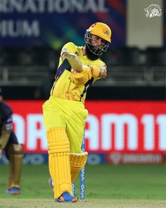 a man in yellow uniform playing a game of cricket