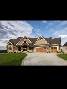 a large house with two garages and lots of windows