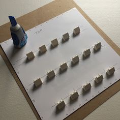 a bunch of white blocks sitting on top of a sheet of paper next to a bottle of toothpaste