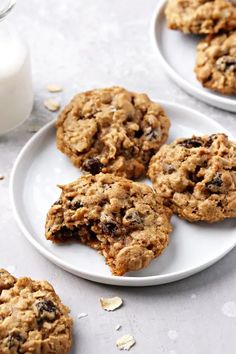 cookies and milk are sitting on two white plates