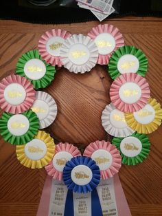 a wreath made out of paper and ribbons