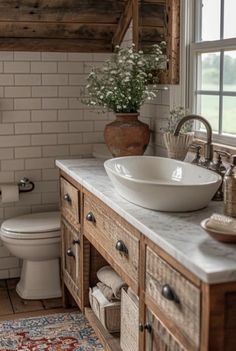 a bathroom with a sink, toilet and rug on the floor in front of it