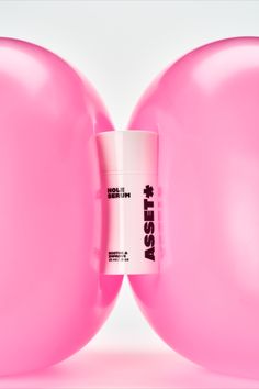 a pink balloon with a white tube in the middle and an advertise on it