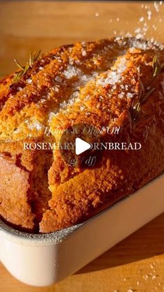 a loaf of bread in a pan with rosemary sprigs on top and the recipe below it