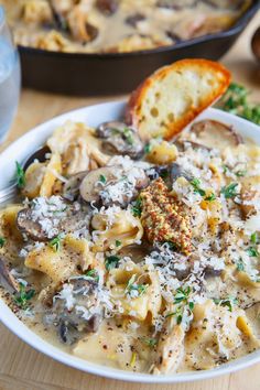 a bowl of pasta with mushrooms and parmesan cheese