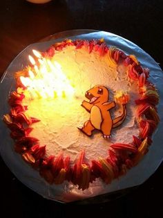 a birthday cake with a cartoon character on it and flames coming out of the top