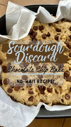 a chocolate chip cookie in a pan with napkins on the side that says sugar dough disccant