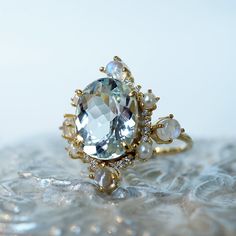 Read about our payment plans before proceeding."Do you want to build a snowman?"- FrozenThe "Aquamarine Elsa Moonstone Pearl Diamond ring" features an approximately 2.54ct oval large natural Aquamarine. Framed with glowy cabochon moonstones, freshwater pearls, and natural white diamonds. Handcrafted in 14k yellow gold, rose gold, and white gold. All orders come in our Tippy Taste ring box. This ring is handmade and designed in NYC. 14K solid gold 10*8mm natural oval Aquamarine. Approx. 2.54ct Fo Luxury Oval Moonstone Wedding Ring, Aquamarine And Pearl Ring, Luxury Moonstone Halo Ring For Wedding, Luxury Moonstone Ring With Gemstone Accents For Gift, Wedding Moonstone Ring With Gemstone Accents In 14k Gold, Celestial Style Moonstone Wedding Ring With Gemstone Accents, Celestial Moonstone Ring With Gemstone Accents For Wedding, Celestial Moonstone Ring For Wedding With Gemstone Accents, Unique Moonstone Ring With Rose Cut Diamonds For Wedding