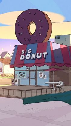 a donut shop with a giant doughnut on top