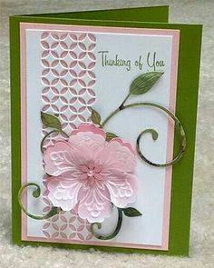 a card with pink flowers and green leaves