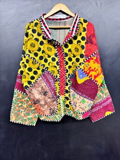 a colorful jacket hanging on a wooden hanger