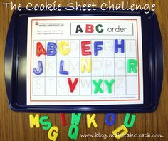 a child's abc and letter poster on a table with the letters in it