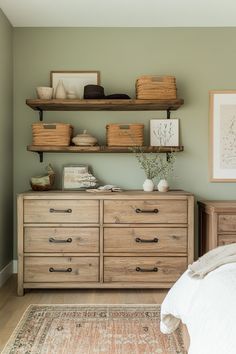 a bed room with a neatly made bed and some shelves on the wall above it