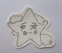 a sticker with a drawing of a star and clouds in the shape of a face