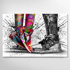 a pair of feet with tattoos and colorful shoes in front of a white wall background