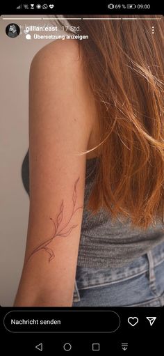 the back of a woman's arm with a small tattoo on her left arm