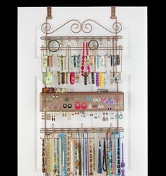 a wall mounted jewelry rack with earrings and bracelets