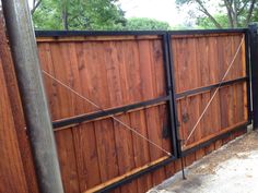 a wooden fence with metal bars on it