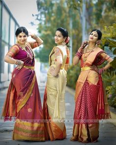 three women in sari standing next to each other