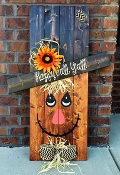 a wooden sign that says happy fall y'all with a sunflower on it