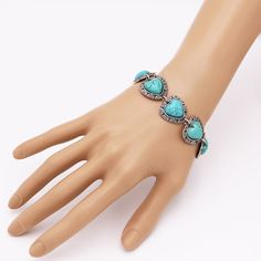 Elevate your accessory collection to the next level with this stunning arm candy bling! But, of course, a western-style wardrobe would only be complete with at least one statement piece of howlite jewelry! Rich turquoise-colored semi-precious howlite stones in decorative metal concho framing. The bracelet measures approximately 7.75 to 8.5 inches with the two-loop adjustable length toggle closure. A stylish silver-tone bracelet with a burnished finish for a vintage look is attached to a large, s Howlite Jewelry, Western Turquoise, Toggle Clasp Bracelet, Heart Stone, Howlite Stone, Cowgirl Chic, Clasp Bracelet, Decorative Metal, Stone Heart