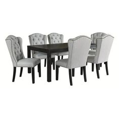 a dining room table and chairs with tufted upholstered backrests on each side