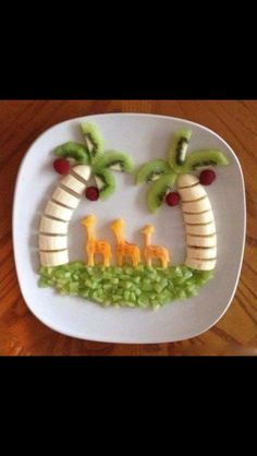 a white plate topped with banana slices and giraffes on it's side