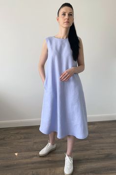 "Handmade MaTuTu Linen Style loose sleeveless washed linen dress with pockets, buttons and belt. The dress can be worn on two sides with the front or back fastening. *100% local medium weight linen *Suitable for maternity *Each item is individually cut and sewn by order *The model is wearing size S, dress color - Light blue *The model height is 168 cm *Note that colors may look different on your display depending on their settings and technical characteristics. Please let us know if you need dif Wrap Dresses Summer, Summer Sleeveless Dress, Blue Linen Dress, Loose Tunic, Dress With Buttons, Summer Linen Dresses, Summer Linen, Sleeveless Dress Summer, Linen Style