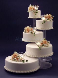 three tiered wedding cake with flowers on top