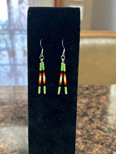 Beautiful beaded drop earrings perfect for those who like a minimalist design. 2 inches long, including hook. Hand made in Oklahoma by an enrolled citizen of Cherokee Nation. Many primary colors to choose from. Hypoallergenic stainless steel hooks used. Colorful Round Beads Earrings For Everyday, Colorful Round Bead Earrings For Everyday, Colorful Beaded Earrings For Everyday, Minimalist Adjustable Beaded Earrings For Gift, Minimalist Earrings With Dangling Beads As Gift, Everyday Colorful Round Beads Earrings, Colorful Beaded Dangle Earrings For Everyday, Minimalist Adjustable Earrings With Dangling Beads, French Hook Beaded Drop Earrings