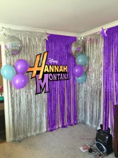 a room with balloons and streamers in the shape of letters for an hannah montana party