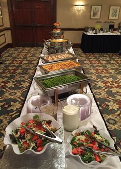 a buffet line with many different types of food on it's sides, including salads and dips