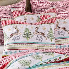 a bed with red and white plaid pillows