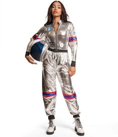 a woman in silver space suit posing for the camera