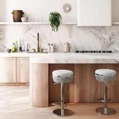 two stools in front of a marble counter top