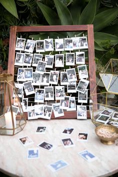 a table with pictures and candles on it