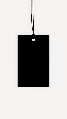 a black square hanging on a string