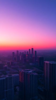 the sun is setting over a city with high rise buildings and skyscrapers in the foreground