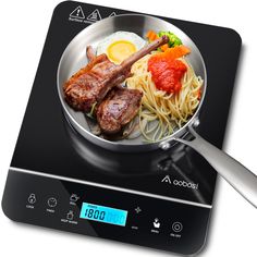 a frying pan with some meat and noodles on the stove top next to a digital scale