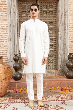 White kurta with silk thread embroidery in floral, aari pattern. Paired with a pant. - Aza Fashions Festive Cotton Silk Kurta With Naqshi Detail, Straight Kurta In Raw Silk With Naqshi, Traditional Raw Silk Kurta With Naqshi, Elegant Cotton Churidar For Diwali, Diwali Lawn Suit With Naqshi In Raw Silk, Festive Chanderi Kurta With Naqshi Detail, Elegant Cotton Sherwani With Dabka Work, Cotton Sherwani With Naqshi For Festivals, Cotton Churidar With Naqshi For Wedding