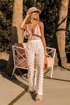 Perfect for wearing over your favorite swimsuit, our adorable white 'Cabana Hour' cover up pants featuring ultra lightweight lace material, a high waistline, and a relaxed silhouette that falls straight into ankle-length hemlines!   Measurements S variant has  a Hip of 42",  a Inseam of 27",  a Length of 38",  a Waist of 24-30".  L variant has  a Hip of 44",  a Inseam of 27.5",  a Length of 39",  a Waist of 26-32". High Waist Bottoms With Lace Trim For Spring, Lace Bottoms For Summer Loungewear, Summer Lace Stretch Bottoms, White Lace Beachwear Bottoms, Stretch Lace Bottoms For Summer, Feminine Bottoms For Spring Vacation, High Waist Lace Pants For Spring, Feminine Spring Vacation Bottoms, Feminine White Lace Bottoms