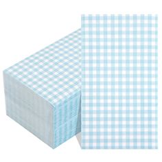 two pieces of blue and white checkered paper next to each other on a white background